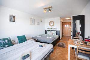a room with two beds and a table in it at Le Cleuson - centré avec vue in Nendaz