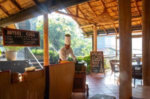 a chef preparing food inside of a restaurant at O2 Villas Ella in Ella