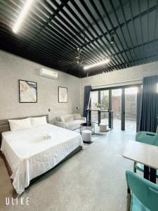 a bedroom with a bed and a living room at Minh Hung Apartment & Hotel in Danang