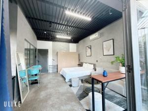 a bedroom with a bed and a desk and a table at Minh Hung Apartment & Hotel in Danang +119 photos