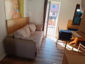 a living room with a couch and a table at Terme Čatež - Family apartments with pool tickets in Čatež ob Savi