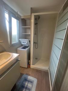 a bathroom with a shower and a sink at Mobil-home 1 in Quimper +18 photos