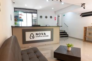 a living room with a television and a couch at NOVA Apartahotel in Medellín