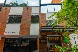 a brick building with the front door open at NOVA Apartahotel in Medellín