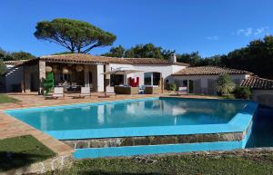 a swimming pool in front of a house at Luxury Villa, Infinity Pool, Beach 5 min in Ramatuelle