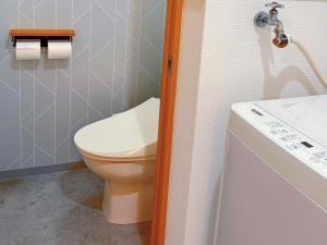 a small bathroom with a toilet and a sink at 星の宿大阪城 in Osaka