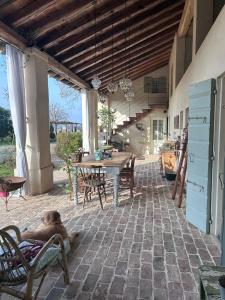 a dog laying in a chair on a patio at Il Glicine - Natural BnB in Castello di Godego