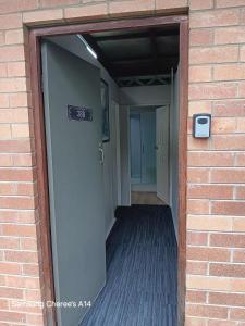an open door to a hallway in a brick building at The Flat 28B on Ordnance in Lithgow