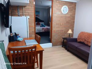 a living room with a table and a couch at The Flat 28B on Ordnance in Lithgow