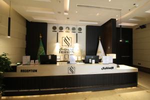 a lobby with a counter with two computers on it at Friesian Hotel Apartments in Jeddah