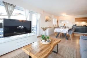 a living room with a large flat screen tv at Christiania Central Nendaz in Nendaz
