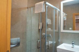 a bathroom with a shower and a sink at Hotel Sliško in Zagreb +86 photos