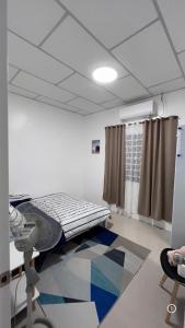 a hospital room with a bed and a window at Thad Transient House - Gensan in General Santos