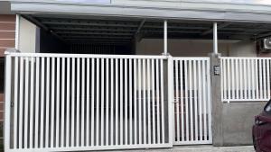 a white fence in front of a house at Thad Transient House - Gensan in General Santos