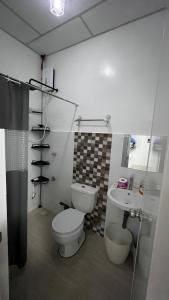 a bathroom with a toilet and a sink at Thad Transient House - Gensan in General Santos +10 photos