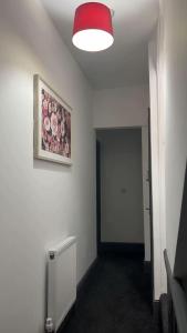 a room with a painting on the wall and a hallway at PLUS Properties Westport 2 in Stoke on Trent