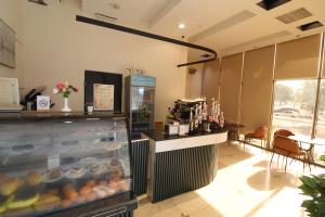 a restaurant with a counter and a bar in a room at Friesian Hotel Apartments in Jeddah +51 photos