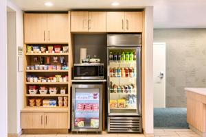 a kitchen with an open refrigerator and a microwave at SpringHill Suites Phoenix Glendale/Peoria in Peoria