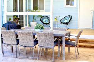 a dining table and chairs on a patio at Goolwa Blue Escape - Beach Spacious Wi-fi in Goolwa