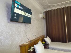a hotel room with a flat screen tv on the wall at BUKHARA Air Hostel in Bukhara