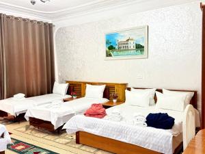 a room with three beds and a table at BUKHARA Air Hostel in Bukhara +38 photos