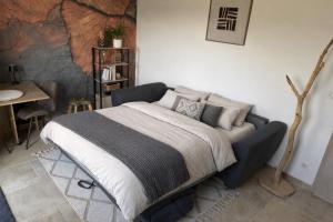 a bedroom with a bed and a table and a tableablish at Entre sabots et ronrons in Butten +30 photos