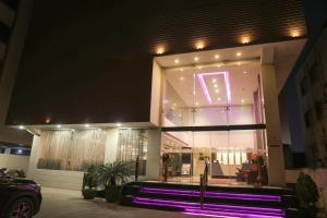 a building with purple lights on the front of it at Veronica Hotel in Vadodara