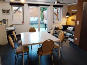 a living room with a white table and chairs at Italia House in Fót