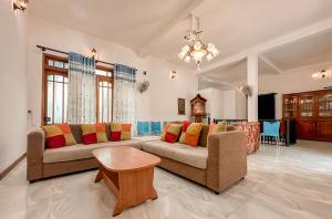 a living room with a couch and a table at Kandy Golden Gate Resort in Kandy