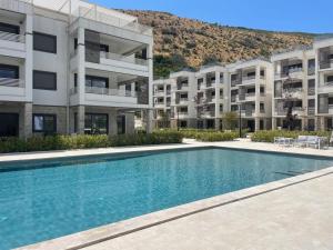 a swimming pool in front of a apartment building at Azure Bay in Igalo