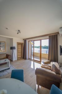 a living room with a couch and a large window at Casa D Argento in Veliko Gradište