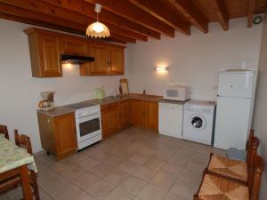a kitchen with a white refrigerator and a washer at Superb villa by the sea in Poggio Mezzana in Saint-Floxel