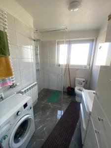 a bathroom with a washing machine and a toilet at Pokoje Gościnne Pod Lasem" in Balice