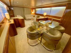 a living room with a glass table and chairs at Yacht FALCON FIVE in Cannes