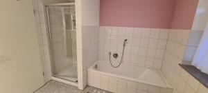 a bathroom with a shower and a white tub at Auszeit in Limbach +2 photos