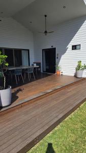 a wooden deck with chairs and a table on a house at Sunshine cottage in Clontarf
