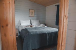 a bed in a room with two animals on it at Guesthouse Skálafell in Skálafell