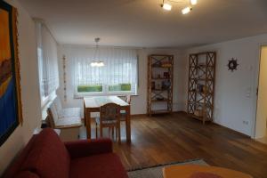 a living room with a table and a window at Auszeit in Limbach