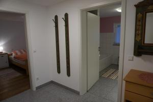 a bathroom with a door to a bathroom with a tub at Auszeit in Limbach