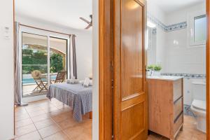 a bathroom with a toilet and a bedroom with a bed at Villa Sea Garden Holidays by 3VILLAS in Port d'Addaia +25 photos