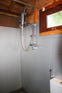 a shower in a bathroom with a toilet at Matara Eco Friendly Treehouse in Matara