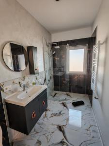 a bathroom with a sink and a marble floor at Dream Home in Giroc