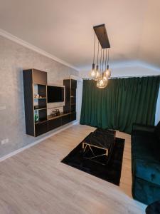 a living room with a green curtain and a couch at Dream Home in Giroc +11 photos