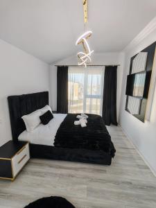 a bedroom with a large bed and a window at Dream Home in Giroc