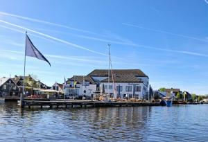 a sail boat docked at a dock on the water at CHALET36 in GROU in Grou