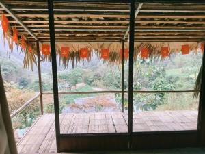 a room with a window with a view of a garden at Puluongholiday homestay2 in Làng Chiêu