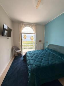 a bedroom with a bed and a window with a view at VillaVenere in Rossano