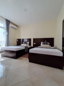 two beds in a room with two bedsitures at Snow View Residences in Msaranga