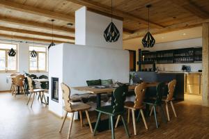 a kitchen and dining room with a wooden table and chairs at Grünbauer - Der Landgasthof in Reuth bei Erbendorf