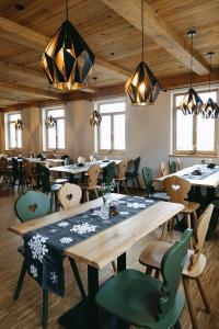 a restaurant with a large wooden table and chairs at Grünbauer - Der Landgasthof in Reuth bei Erbendorf +16 photos